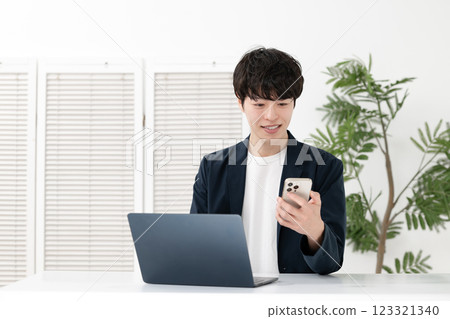 Man using a computer Man using a computer 123321340