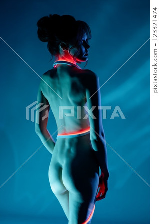Sensual beauty in neon light during a nighttime photo session 123321474