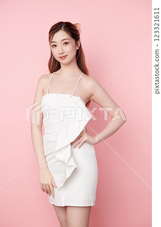 Beautiful face of young Asian woman in sexy dress white Perfect slim body on pink background, plastic surgery and aesthetic cosmetology, Facial and skin care concept 123321611