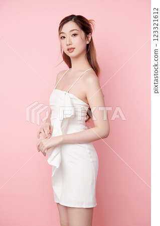 Beautiful face of young Asian woman in sexy dress white Perfect slim body on pink background, plastic surgery and aesthetic cosmetology, Facial and skin care concept 123321612