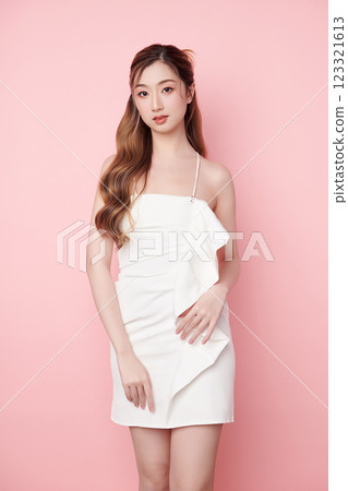 Beautiful face of young Asian woman in sexy dress white Perfect slim body on pink background, plastic surgery and aesthetic cosmetology, Facial and skin care concept 123321613