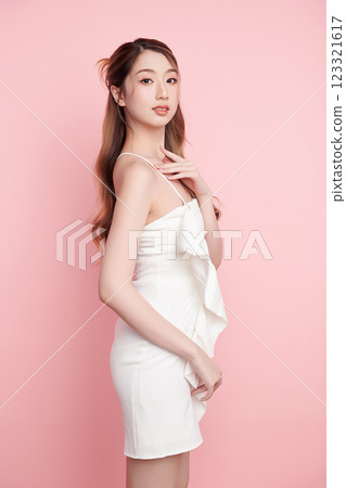 Beautiful face of young Asian woman in sexy dress white Perfect slim body on pink background, plastic surgery and aesthetic cosmetology, Facial and skin care concept Beautiful face of young Asian woman in sexy dress white Perfect slim body on pink background, plastic surgery and aesthetic cosmetology, Facial and skin care concept 123321617