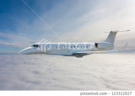 White modern luxury private jet flies in the air above the clouds 123322027
