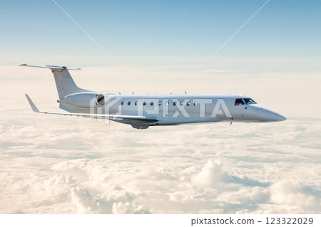 White business jet flies in the air above the clouds 123322029