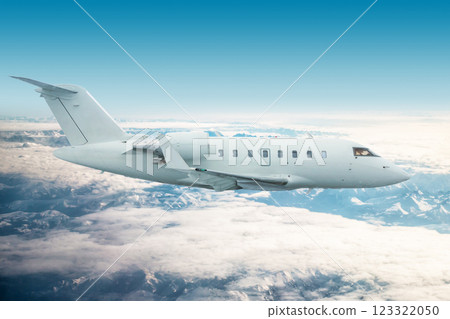 White modern executive jetliner flies over snow-covered mountains White modern executive jetliner flies over snow-covered mountains 123322050