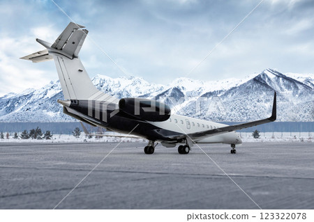 Corporate plane at winter airport on the background of snow capped mountains 123322078