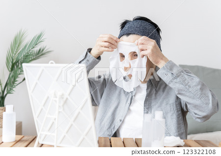 Middle-aged man using face mask, dry skin, moisturizing, face care 123322108