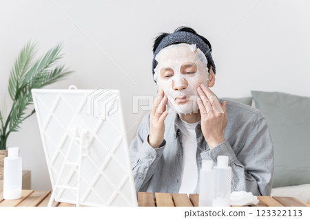 Middle-aged man using face mask, dry skin, moisturizing, face care Middle-aged man using face mask, dry skin, moisturizing, face care 123322113