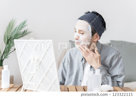 Middle-aged man using face mask, dry skin, moisturizing, face care 123322115