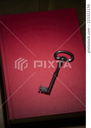 Antique red book and key Antique red book and key 123322156