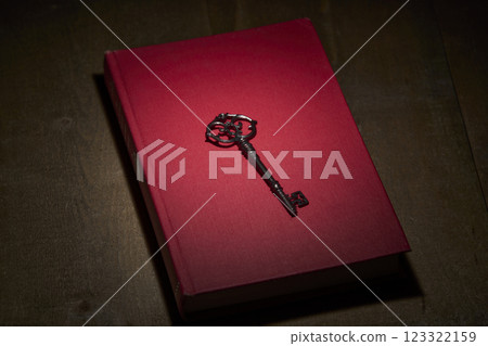 Antique red book and key Antique red book and key 123322159