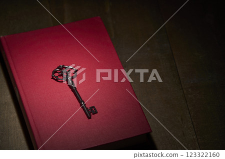 Antique red book and key Antique red book and key 123322160