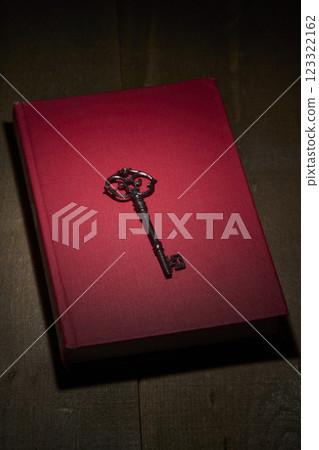 Antique red book and key Antique red book and key 123322162