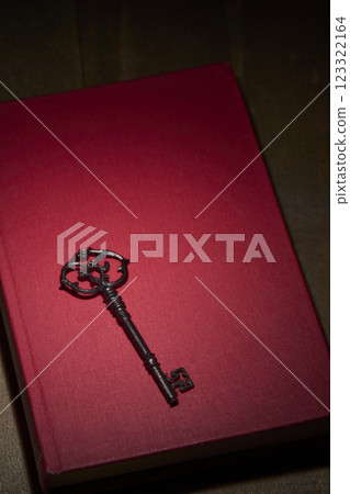 Antique red book and key Antique red book and key 123322164