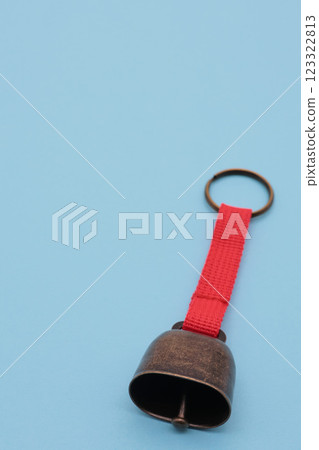 Bear repellent bell on light blue background 123322813