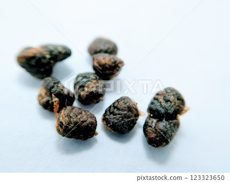 A picture of black seeds on white background A picture of black seeds on white background 123323650