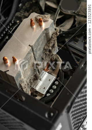 Dusty CPU cooler inside a computer. Neglected maintenance, overheating risk, and potential hardware damage. 123323891