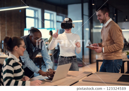 Disabled businesswoman in a wheelchair working in modern coworking office. Team around is using virtual reality goggles, collaborating with the latest technology in an open space startup creative Disabled businesswoman in a wheelchair working in modern coworking office. Team around is using virtual reality goggles, collaborating with the latest technology in an open space startup creative 123324589