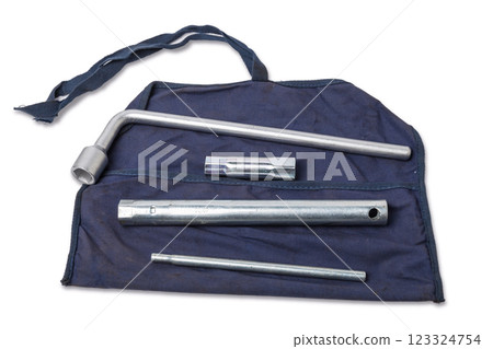 Wheel wrench and transportation hook on a blue cover for car repair on the road in the absence of insurance on a white isolated background. Wheel wrench and transportation hook on a blue cover for car repair on the road in the absence of insurance on a white isolated background. 123324754
