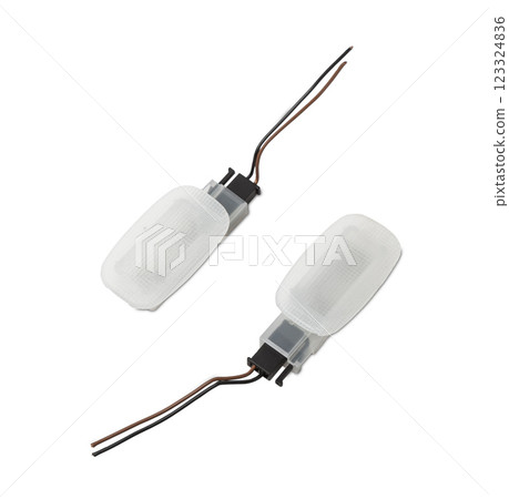 A pair of transparent plastic shades for illuminating the interior on a white isolated background in a photo studio - spare parts for repairing a car interior or for sale in a auto service A pair of transparent plastic shades for illuminating the interior on a white isolated background in a photo studio - spare parts for repairing a car interior or for sale in a auto service 123324836