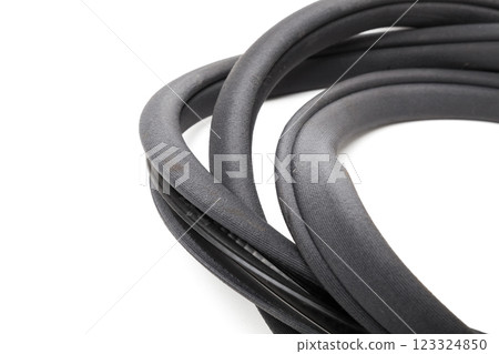 Rolled up black rubber sealant for elements of the car body, doors or trunk, for noise insulation, thermal and sound, preventing heat loss in the car interior. Sealing gasket for repair in a workshop 123324850
