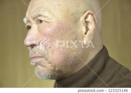 An old man with a beard and a troubled face 123325146