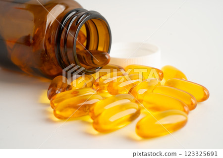 Fish oil or Cod liver oil gel in capsules with omega 3 vitamins, supplementary healthy food. Fish oil or Cod liver oil gel in capsules with omega 3 vitamins, supplementary healthy food. 123325691