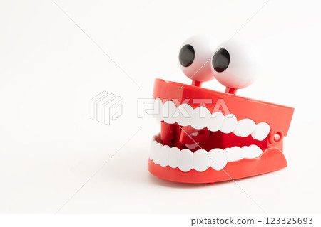 Funny red teeth with eye toy denture model for dental health care. 123325693