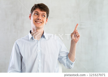 Portrait of young guy gesturing in studio Portrait of young guy gesturing in studio 123327071