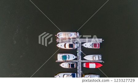 drone overhead view of a docked boat at a marina drone overhead view of a docked boat at a marina 123327729