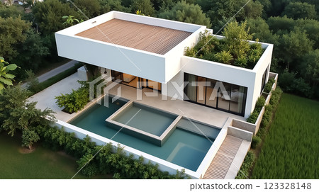 Modern architectural design of a luxury home with greenery and pool surrounded by nature 123328148