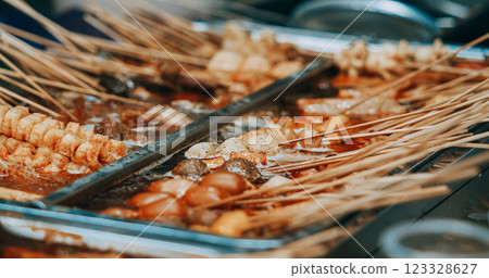 Traditional Chinese Meat Snacks On Bamboo Sticks. Skewered Meat. Chinese Street Food. Street Barbecue. Asian Street Food. Asian Cuisine. Fried Squid, Meat, Potato Traditional Chinese Meat Snacks On Bamboo Sticks. Skewered Meat. Chinese Street Food. Street Barbecue. Asian Street Food. Asian Cuisine. Fried Squid, Meat, Potato 123328627