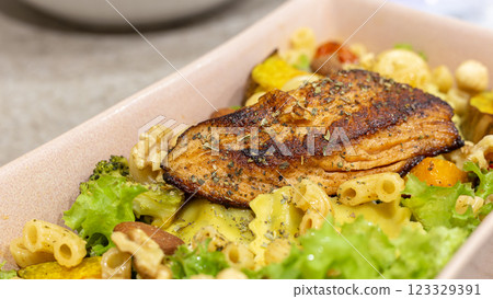 Healthy and delicious: A perfect combination of roasted salmon, fish, rice and salad Healthy and delicious: A perfect combination of roasted salmon, fish, rice and salad 123329391