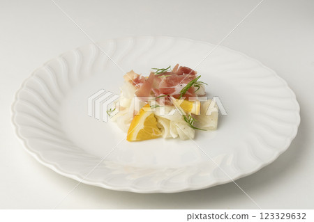 Prosciutto and radish salad served on a white plate Prosciutto and radish salad served on a white plate 123329632
