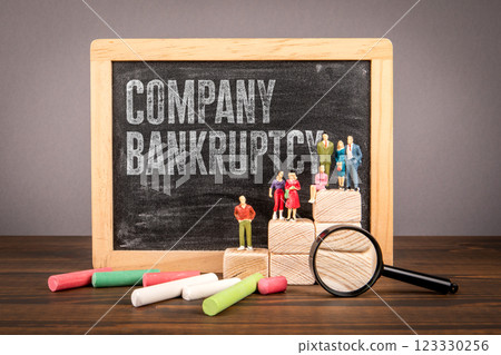 Company Bankruptcy. Miniature human figures on a wooden table Company Bankruptcy. Miniature human figures on a wooden table 123330256
