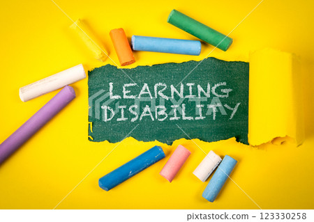 Learning Disability. Text under torn yellow paper on a green chalkboard Learning Disability. Text under torn yellow paper on a green chalkboard 123330258