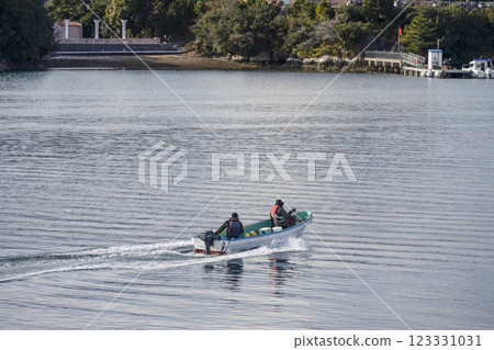 Fishing boat sailing in Ago Bay 123331031