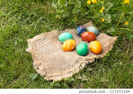 Easter eggs and a sackcloth bag on green grass. Easter eggs and a sackcloth bag on green grass. 123331184