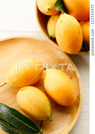 Plum Mango or Marian Plum fruit in wooden tray. Plum Mango or Marian Plum fruit in wooden tray. 123331475