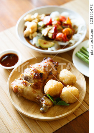 Grilled chicken with fried white rice on wooden tray. Grilled chicken with fried white rice on wooden tray. 123331478