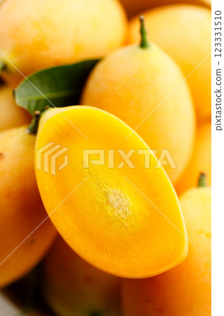 Plum Mango or Marian Plum fruit in wooden tray. Plum Mango or Marian Plum fruit in wooden tray. 123331510