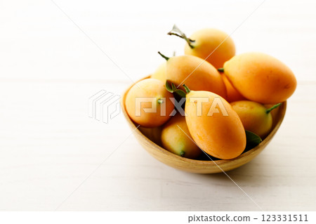 Plum Mango or Marian Plum fruit in wooden tray. Plum Mango or Marian Plum fruit in wooden tray. 123331511