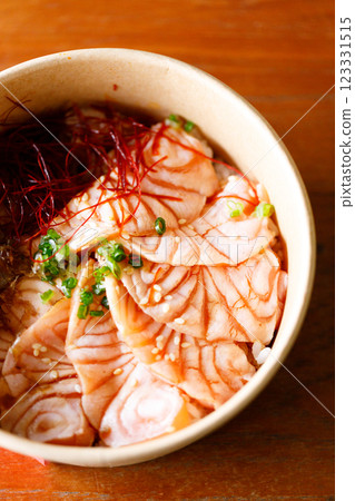 Donburi with sliced salmon on sushi rice in paper container. Healthy take away food. Donburi with sliced salmon on sushi rice in paper container. Healthy take away food. 123331515
