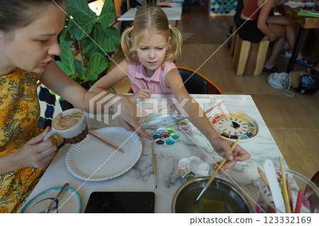 A young mother and her daughter enjoy a creative art session at home A young mother and her daughter enjoy a creative art session at home 123332169