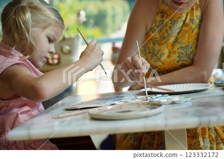 A young mother and her daughter enjoy a creative art session at home  123332172