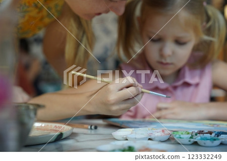 A young mother and her daughter enjoy a creative art session at home A young mother and her daughter enjoy a creative art session at home 123332249