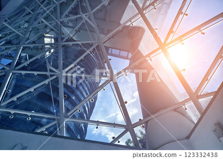 A modern tall building that features a significant amount of glass 123332438