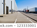 concrete parking lot and warehouse with trucks 123333001