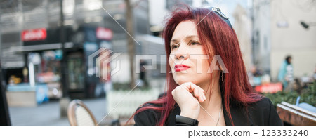 Banner beautiful happy millennial woman with long red hair enjoying day in a street cafe copy space Banner beautiful happy millennial woman with long red hair enjoying day in a street cafe copy space 123333240