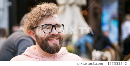 Banner bearded man having breakfast at table of street cafe on spring day, drinking warm cappuccino and enjoy morning. Copy space Banner bearded man having breakfast at table of street cafe on spring day, drinking warm cappuccino and enjoy morning. Copy space 123333242